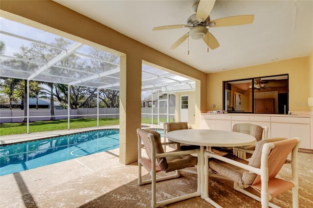 exterior space featuring a fenced in pool, a patio, a ceiling fan, glass enclosure, and fence