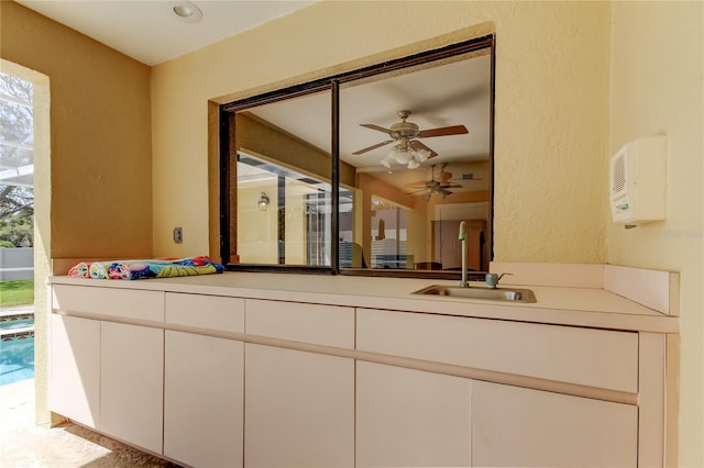 bathroom featuring a textured wall and vanity