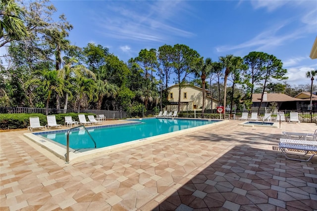 pool featuring fence and a patio