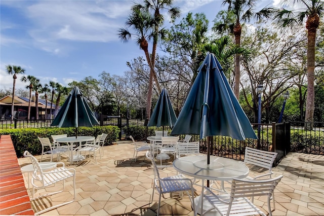 view of patio featuring outdoor dining space and fence