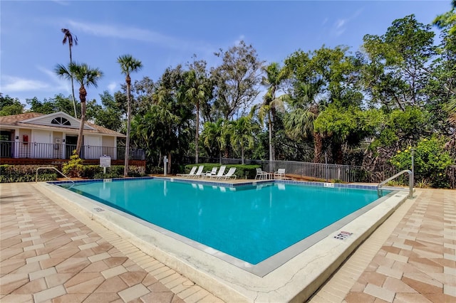 pool featuring a patio area and fence