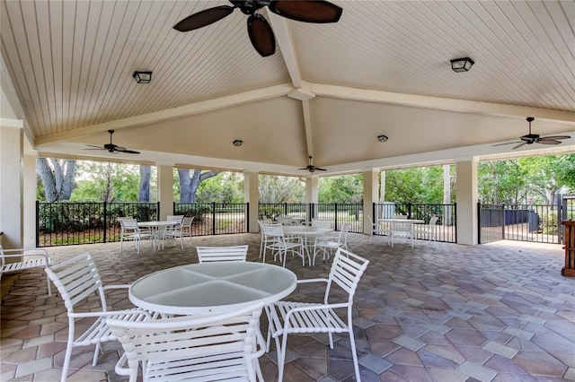 view of patio featuring fence, a ceiling fan, and outdoor dining space