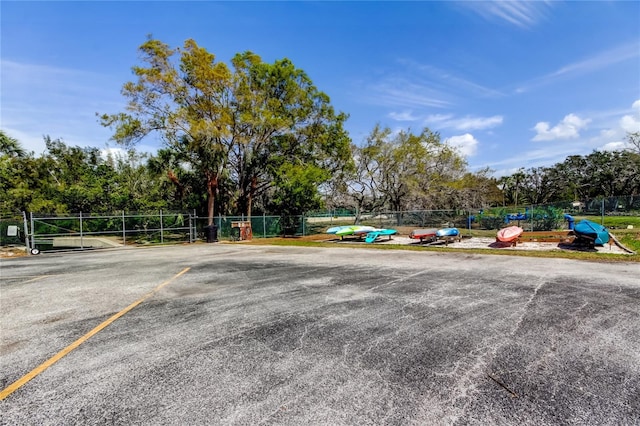 surrounding community with uncovered parking and fence