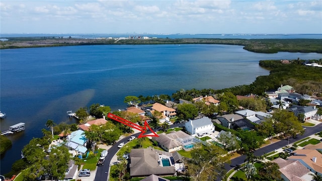 birds eye view of property with a water view and a residential view