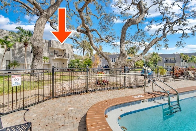 view of pool featuring fence