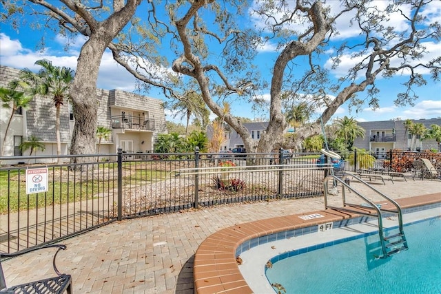 view of pool featuring fence