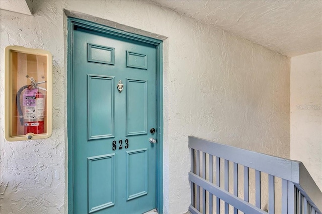 doorway to property with stucco siding