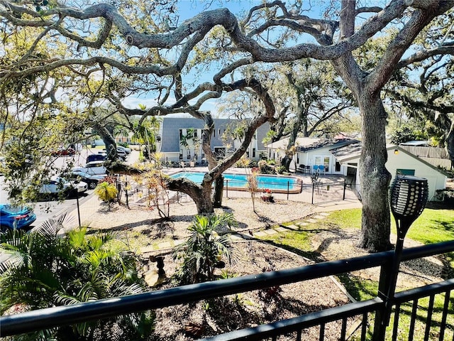 view of yard featuring mail area, fence, and a community pool