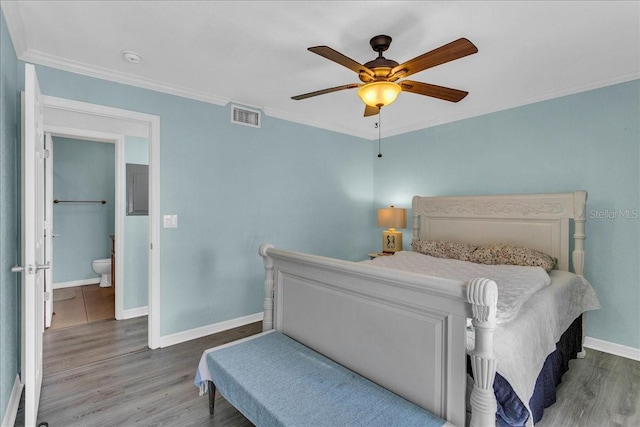 bedroom with baseboards, visible vents, a ceiling fan, wood finished floors, and crown molding