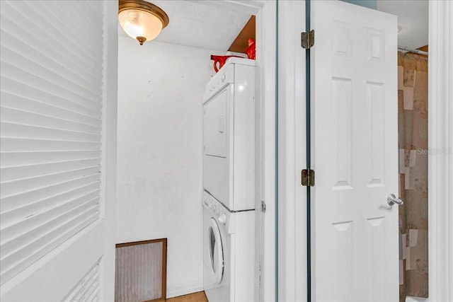 clothes washing area with laundry area and stacked washer / dryer