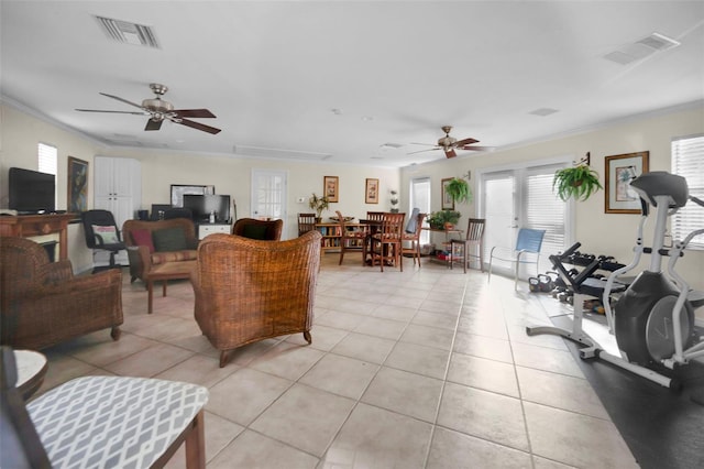 living room featuring visible vents, crown molding, and light tile patterned flooring