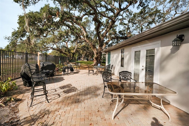 view of patio with outdoor dining area and fence