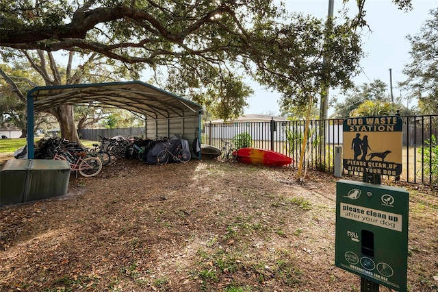 view of yard featuring fence and a carport