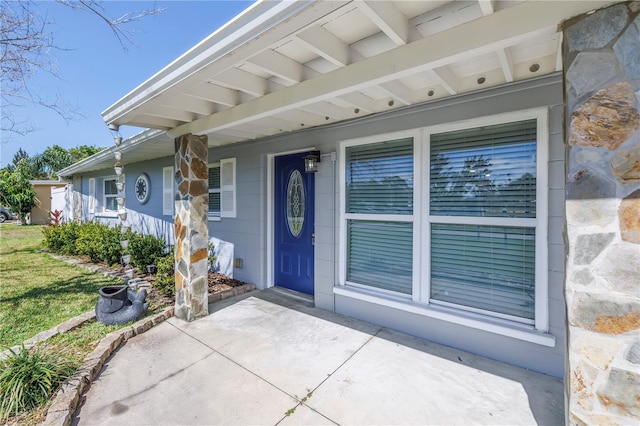 view of exterior entry featuring a porch