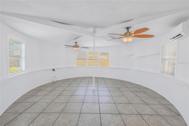 unfurnished room with ceiling fan, beam ceiling, a wall unit AC, and a wealth of natural light