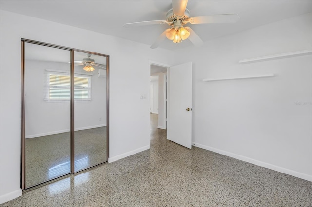 unfurnished bedroom featuring a ceiling fan, a closet, baseboards, and speckled floor