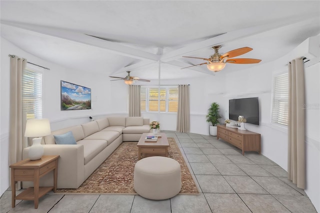 living area with light tile patterned floors, vaulted ceiling with beams, a ceiling fan, and a healthy amount of sunlight