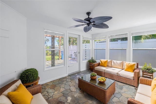 sunroom / solarium featuring a wealth of natural light and a ceiling fan