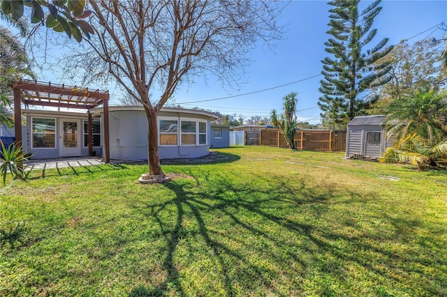 view of yard featuring a storage unit, fence, a pergola, and an outbuilding