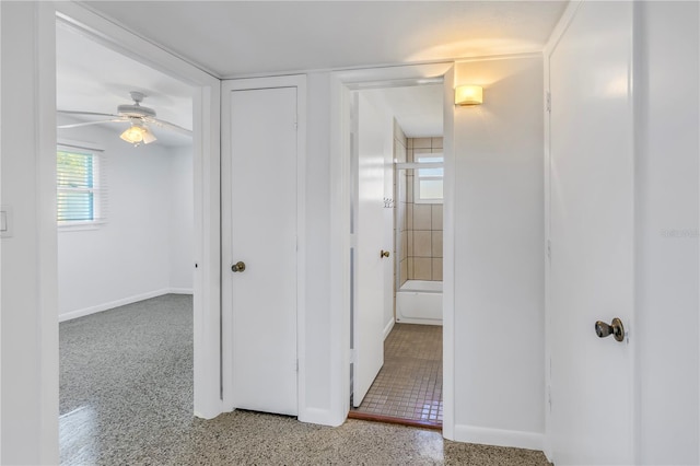 hallway featuring baseboards