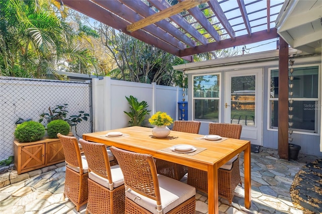 view of patio featuring outdoor dining area, fence, and a pergola