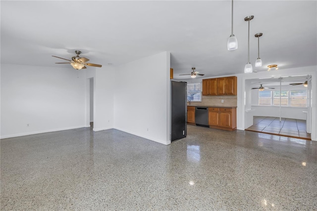 unfurnished living room with a ceiling fan, baseboards, and speckled floor