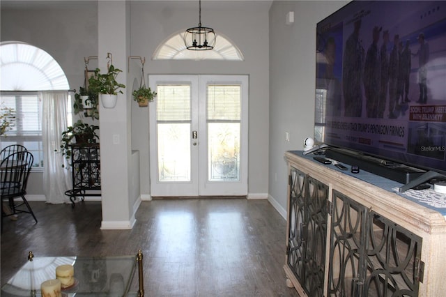 entryway with french doors, dark wood finished floors, and baseboards