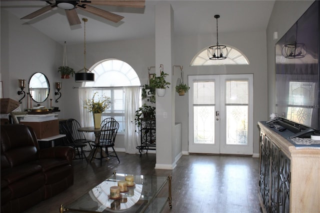 living area with ceiling fan with notable chandelier, french doors, baseboards, and wood finished floors