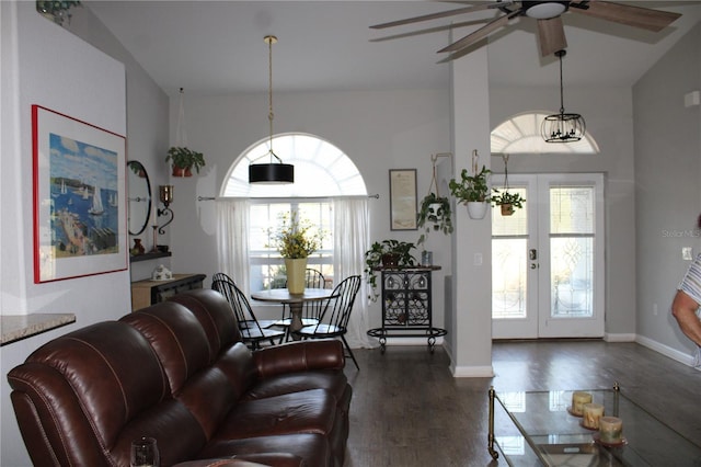 living room featuring a high ceiling, baseboards, wood finished floors, and french doors