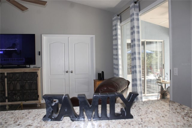 interior space with vaulted ceiling and ceiling fan