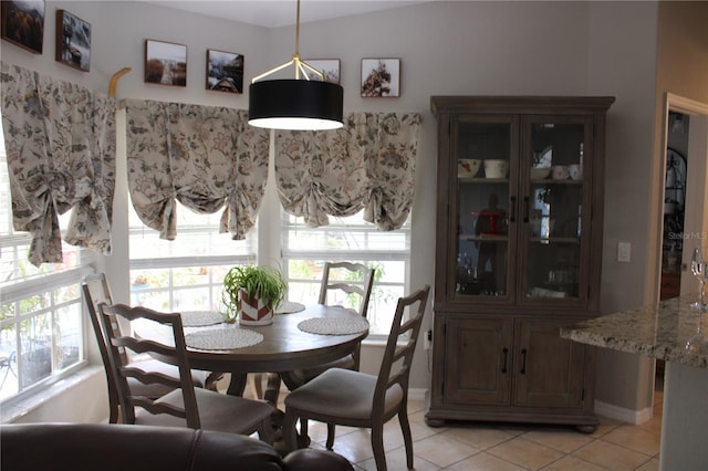 dining room featuring light tile patterned floors and baseboards