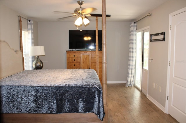 bedroom with ceiling fan, baseboards, and wood finished floors