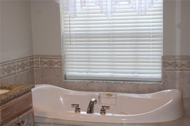 bathroom with vanity and a bath