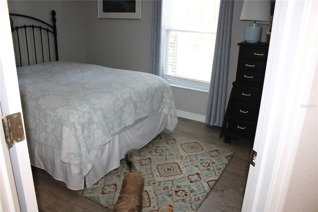 bedroom with wood finished floors and baseboards