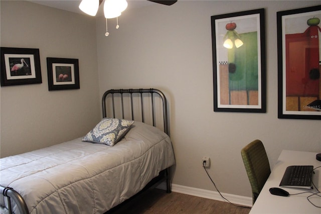 bedroom featuring baseboards and wood finished floors