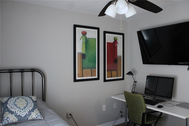 bedroom featuring ceiling fan and baseboards