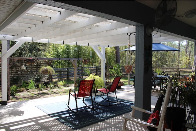 view of patio / terrace with outdoor dining area, fence, and a pergola