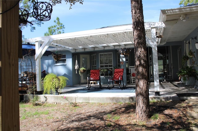 rear view of house with a patio area and a pergola