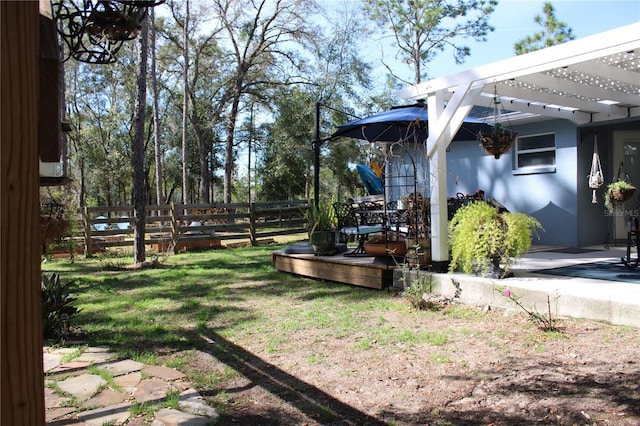 view of yard with fence, a deck, and a pergola