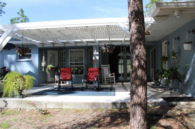 rear view of property with a patio and a pergola