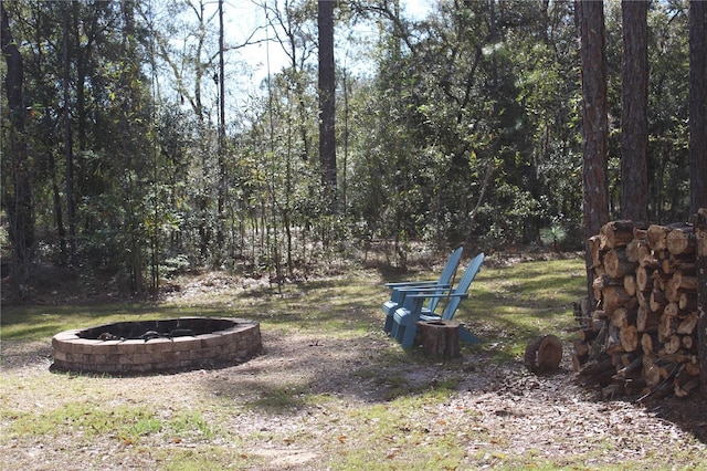 view of yard with an outdoor fire pit