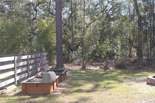 view of yard featuring a vegetable garden and fence