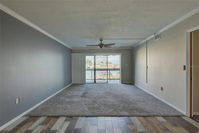 empty room with baseboards, ornamental molding, and a textured ceiling