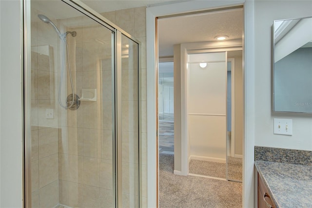 full bathroom featuring a shower stall and vanity