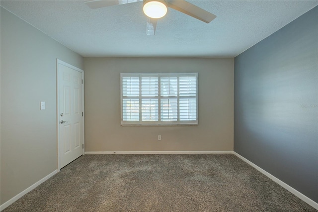 spare room with ceiling fan, a textured ceiling, baseboards, and carpet flooring