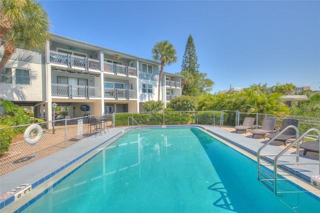 pool featuring a patio and fence