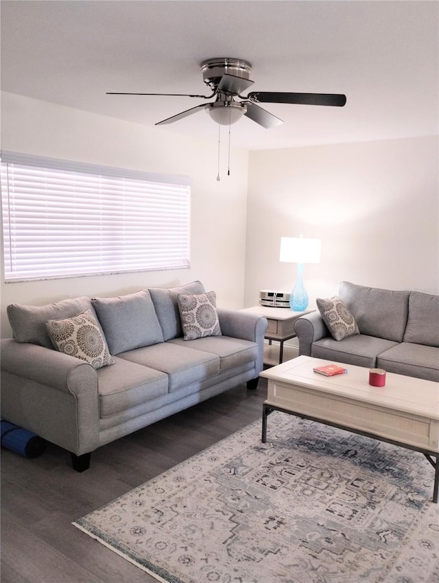 living room with a ceiling fan and wood finished floors