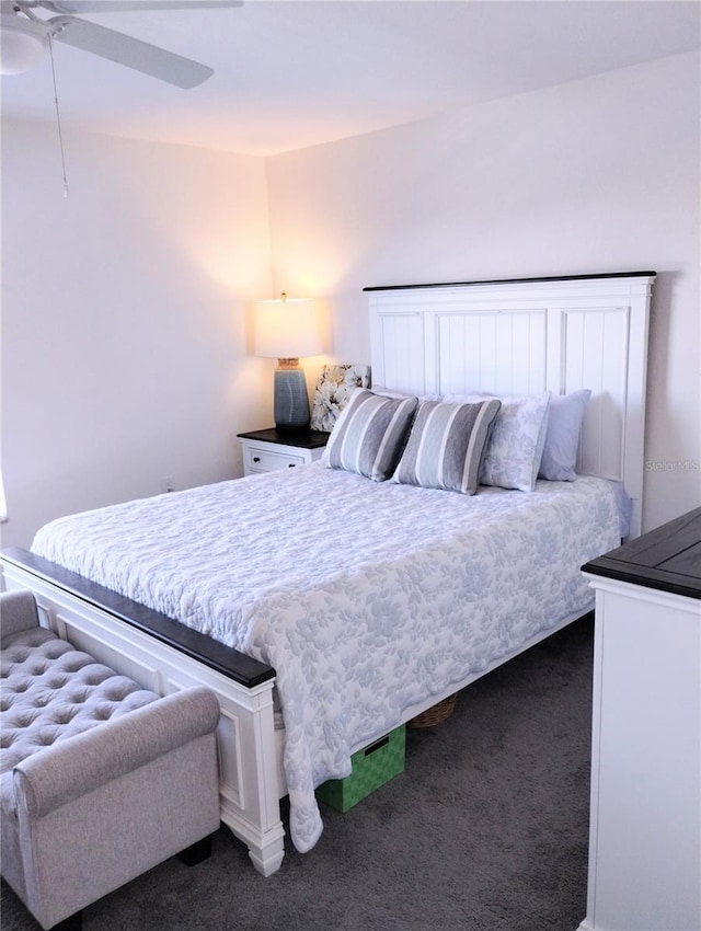 bedroom featuring ceiling fan and dark colored carpet