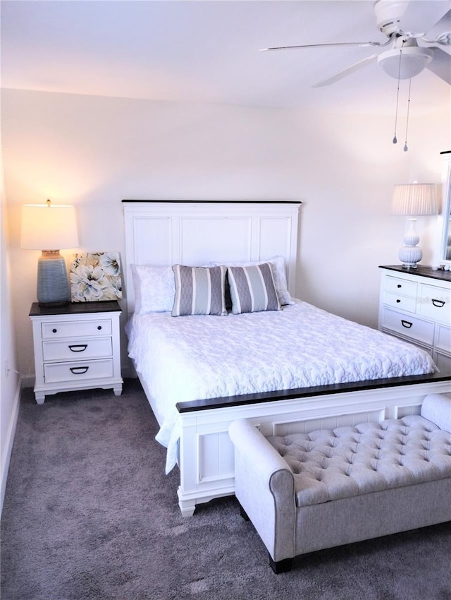 bedroom with ceiling fan and dark colored carpet