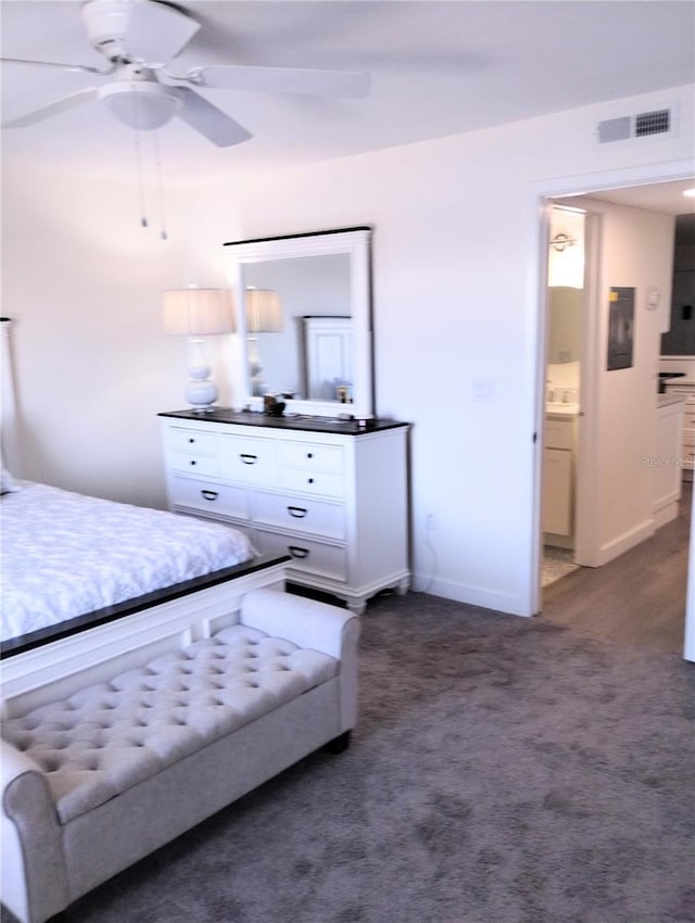 bedroom featuring a ceiling fan, visible vents, dark carpet, and baseboards